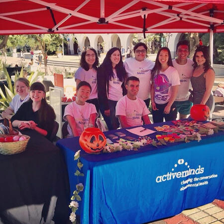 Group of members tabling for a Halloween outreach on campus.